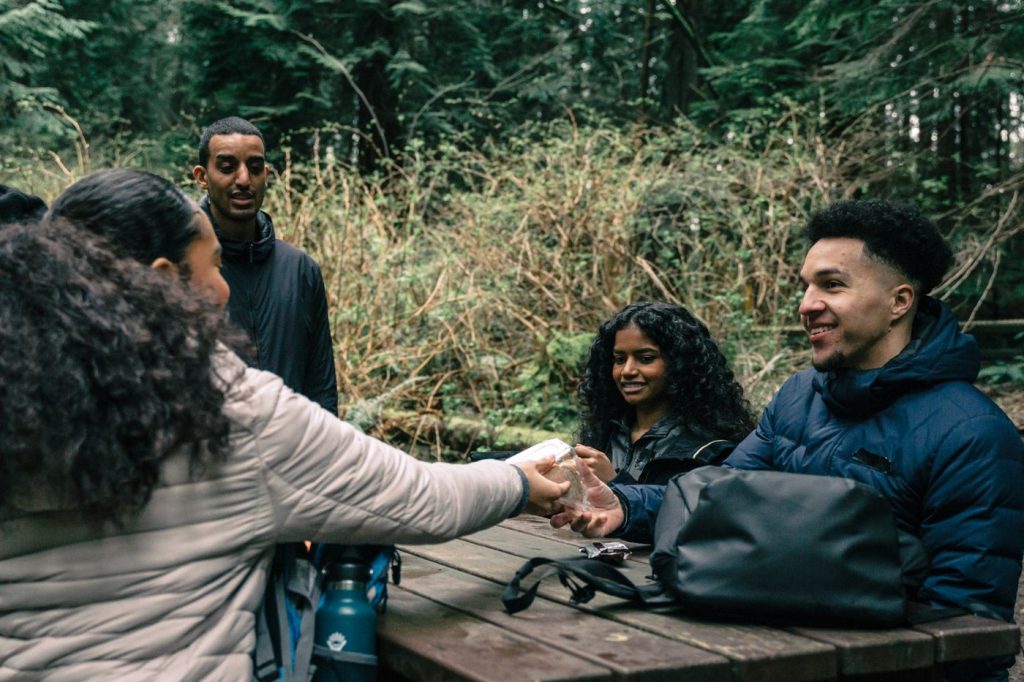 Friends sharing conversation around an outdoor table.